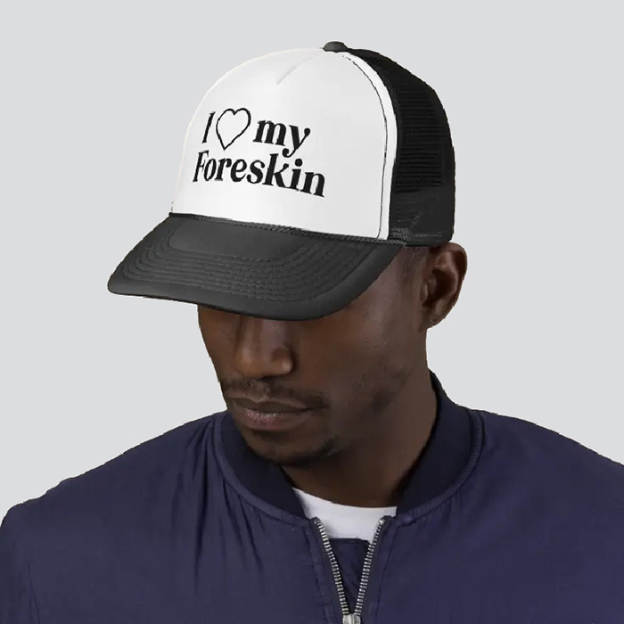 Man in a black and white hat that says 'I love my foreskin'