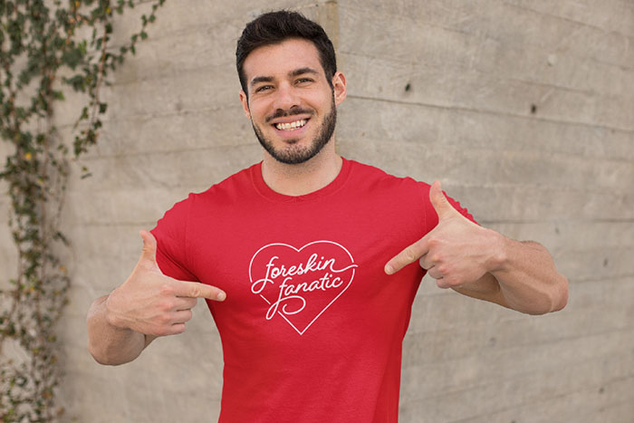 Man in a red shirt that says 'foreskin fanatic' inside a heart