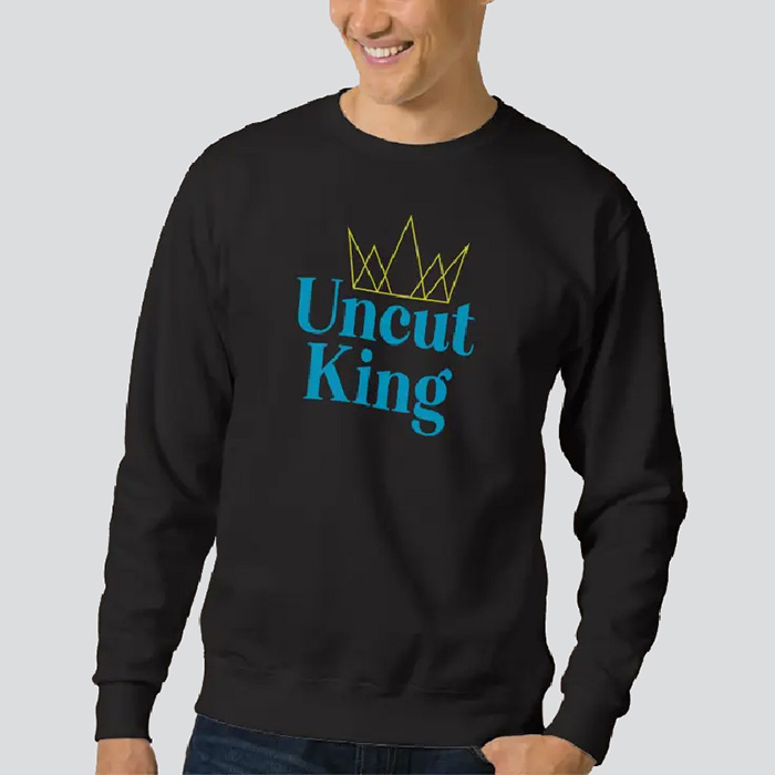 Man in a black sweatshirt that says Uncut King'' in blue