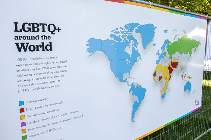 Large panel hanging in the exhibit with the text 'LGBTQ+ around the WOrld' with a color-coded world map