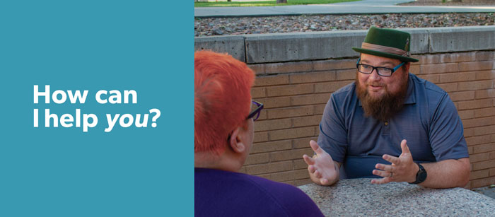 Banner image of TJ talking to a citizen with a turquoise box containing the text 'How can I help you?' on the left