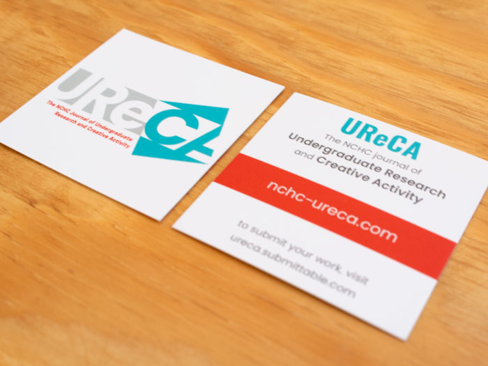Square-shaped UReCA business cards, which have the logo on the front and website information on the back