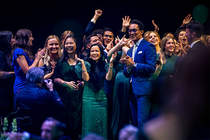 Group of people on stage clapping
