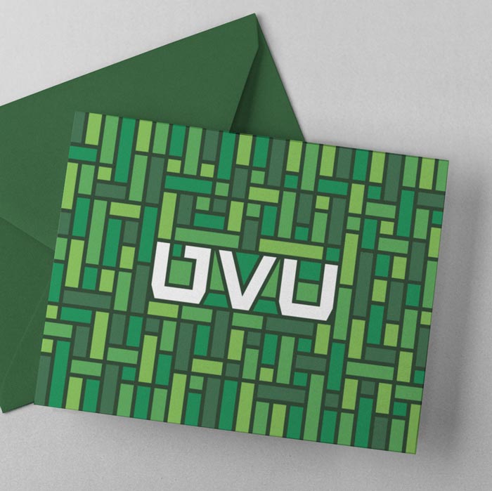 Green mosaic pattern surrounding the UVU monogram