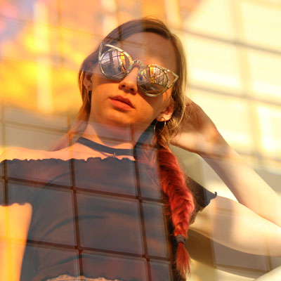 Model posing with light reflecting through glass