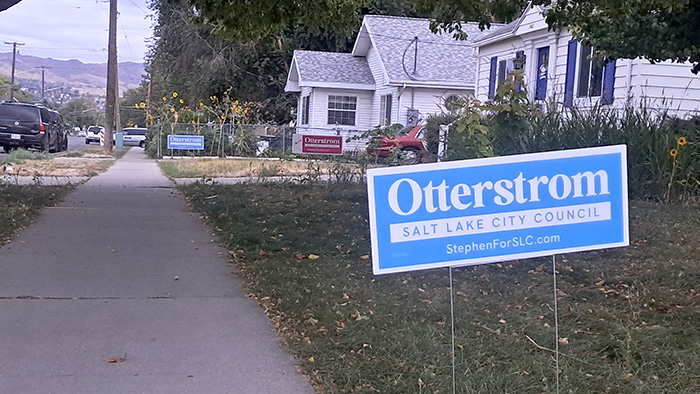 Photo of three yard signs in front of houses