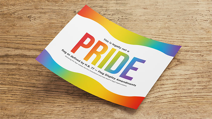 Poster that says 'This is legally not a PRIDE flag' with a rainbow color scheme