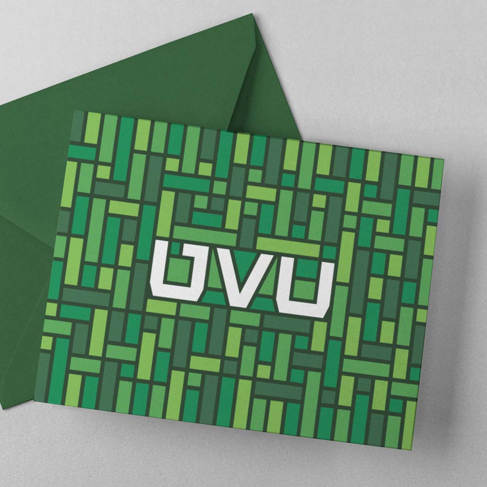 Green mosaic pattern surrounding the UVU monogram